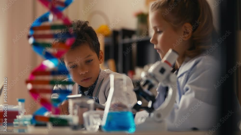 Students in a science class conducting lab experiment, typing results on tablet Students in a science class conducting lab experiment, typing results on tablet