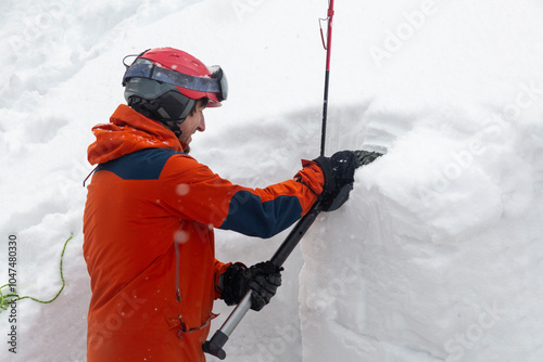 With shovel in hand, a backcountry explorer reads nature's winter diary, written in layers of compressed snow