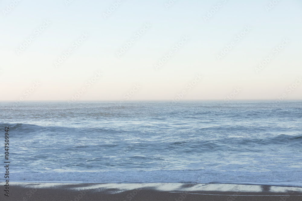 Fototapeta premium Beach and sea background, view of the Atlantic ocean, from a city in Europe.