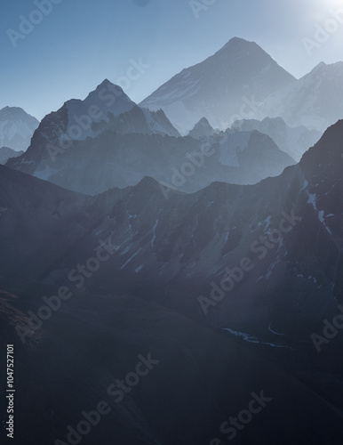 Sunbeams and shadows over Everest and other mountain ridges in the Himalayas, Nepal.