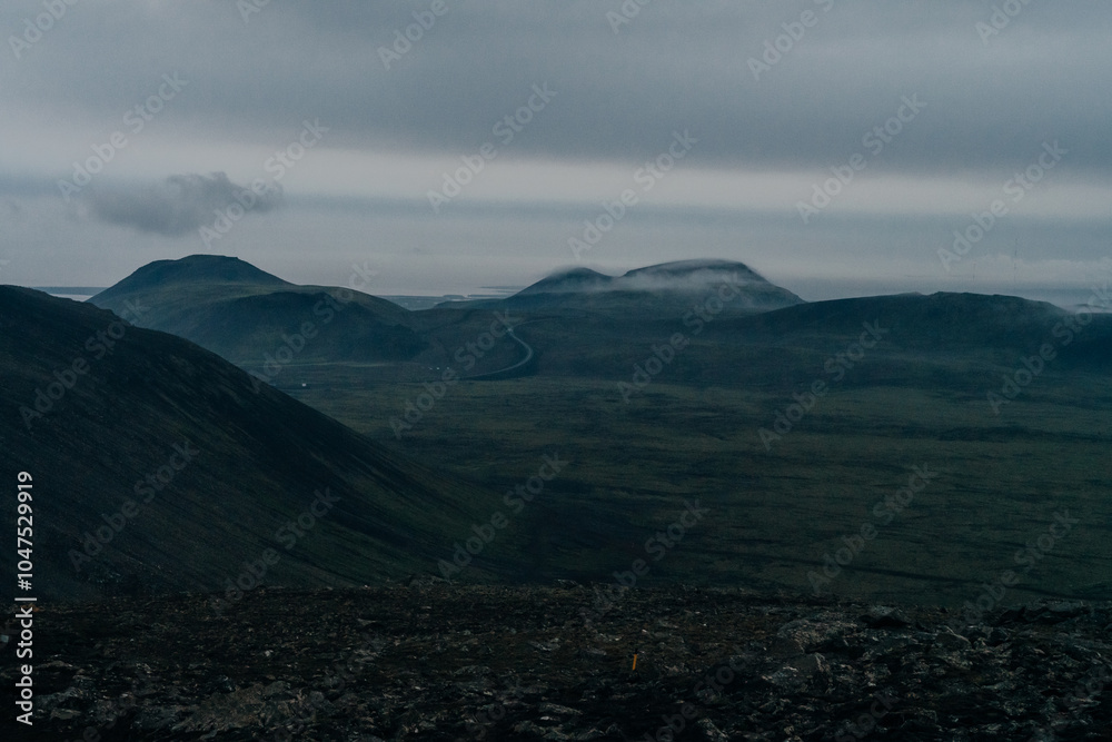 Epic panorama of Icelandic highland landscape: black volcanic mountains covered with soft green moss Epic panorama of Icelandic highland landscape: black volcanic mountains covered with soft green moss