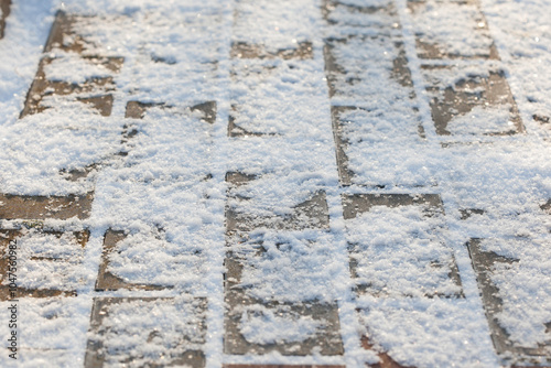 concrete pavement covered with sparkling snow on a sunny winter day photo