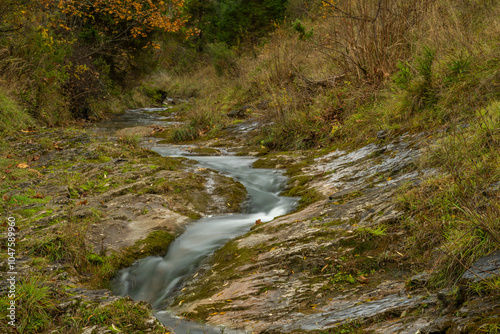 Small creek near Jaworki village of Biala Woda in autumn day photo