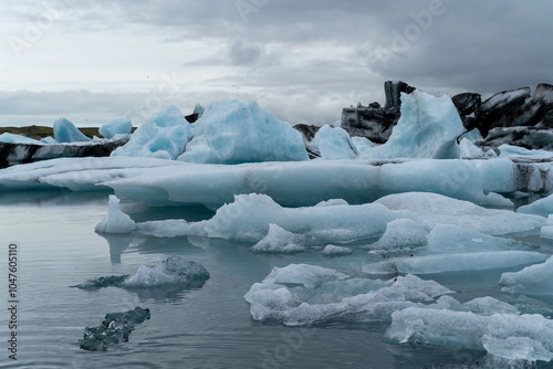 Iceland's blue ice floats on water next to a glacier