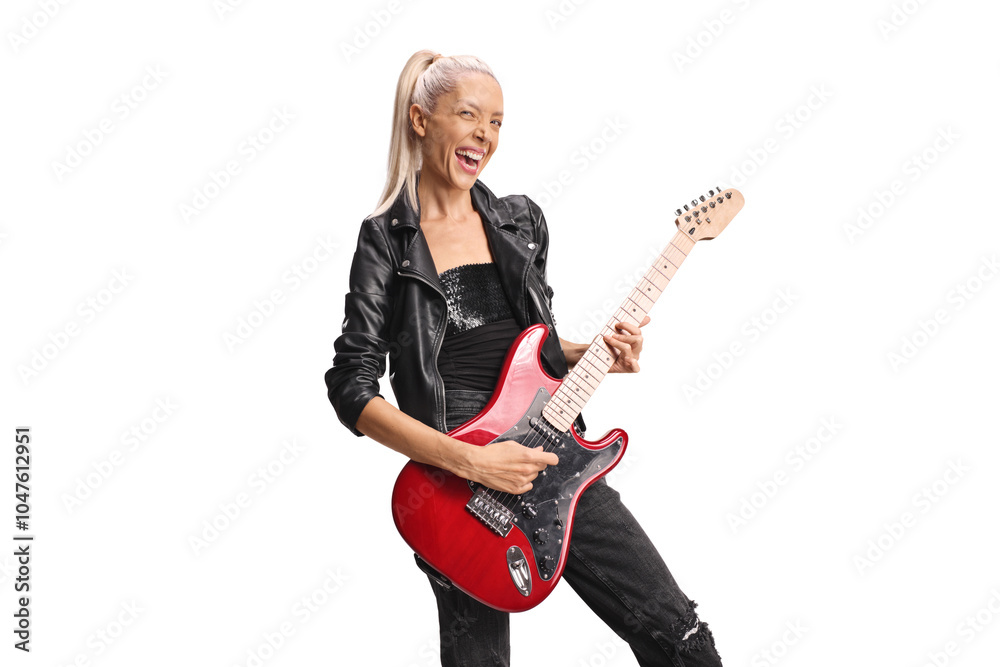Cheerful female rock musician playing a guitar Cheerful female rock musician playing a guitar