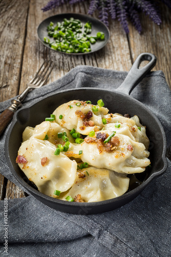 Fried dumplings (pierogi) with meat filling sprinkled with greaves. photo