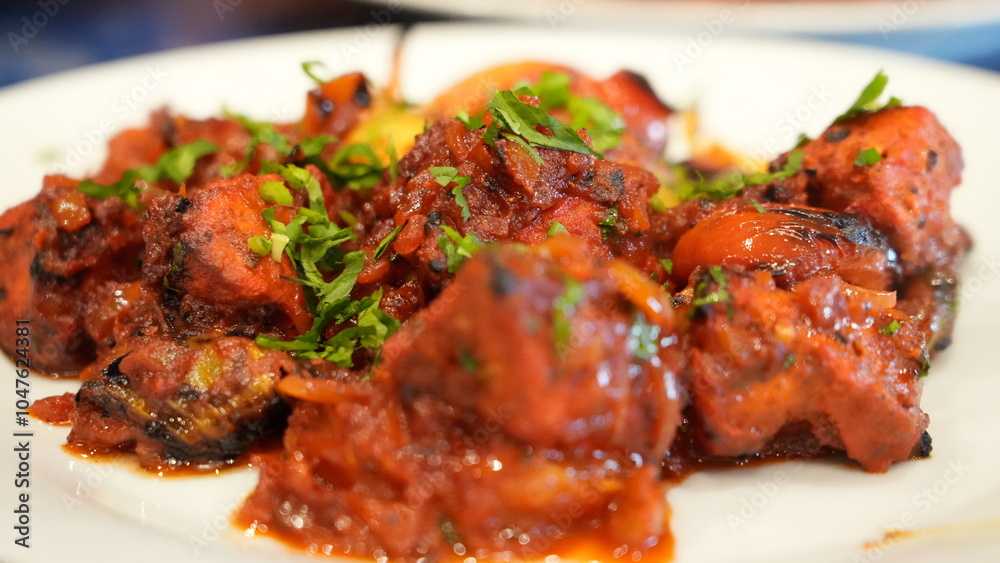 Colorful dish a spicy tomato-based stew featuring tender chunks of meat or vegetables with vibrant bell peppers and garnished with fresh cilantro. Colorful dish a spicy tomato-based stew featuring tender chunks of meat or vegetables with vibrant bell peppers and garnished with fresh cilantro.