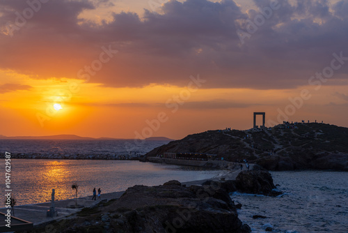 Sunset at the Naxos Harbor, Statue of Aphrodite and the Portara gate of the Temple of Apollo in Naxos, Cyclades, Greece photo