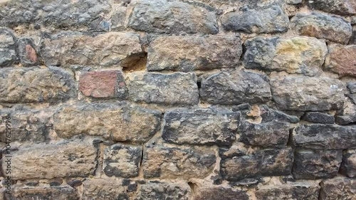 Exploring a Historic Stone Wall in an Ancient Castle Garden