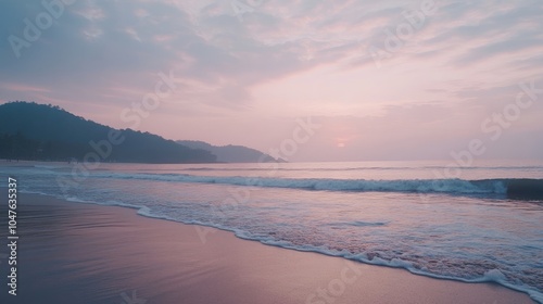 A tranquil sunrise at Palolem Beach, with soft pastel colors illuminating the sky and waves gently breaking on the shore.