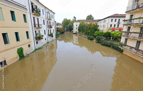 n river is lapping at the foundations of flood-risk homes during a deluge caused by torrential downpours