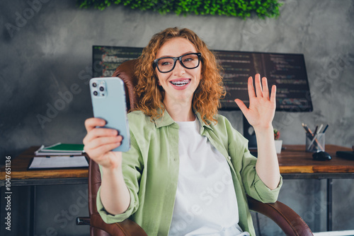 Portrait of young girl computer it specialist smart phone selfie hand wave hi wear shirt workplace office indoors photo