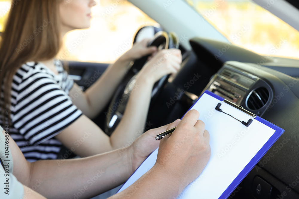 Driving school. Student passing driving test with examiner in car, closeup Driving school. Student passing driving test with examiner in car, closeup