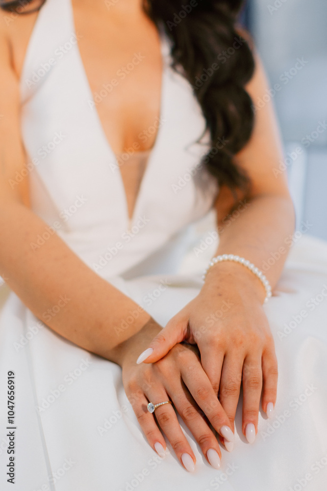Elegant bridal hands with diamond ring in satin robe. Elegant bridal hands with diamond ring in satin robe.