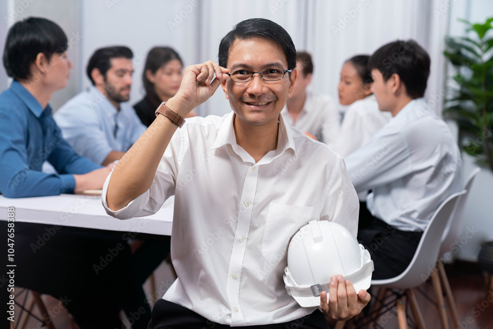 Engineer team leader portrait with diverse group of civil engineer and client working together on architectural project, reviewing construction plan and building blueprint at meeting table. Prudent Engineer team leader portrait with diverse group of civil engineer and client working together on architectural project, reviewing construction plan and building blueprint at meeting table. Prudent