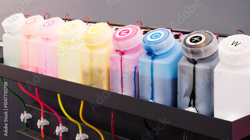 row ink tanks with different colors. tanks are connected to machine that dispenses ink. Concept of creativity and the importance of having variety of colors to create unique, Inkjet printer cartridges photo