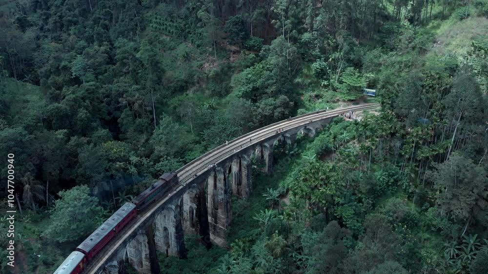 Red train crossing the 9 Arch bridge in Sri Lanka. Cinematic, aerial, drone footage. Sunrise. Clip part of a set of 18 videos. Red train crossing the 9 Arch bridge in Sri Lanka. Cinematic, aerial, drone footage. Sunrise. Clip part of a set of 18 videos.