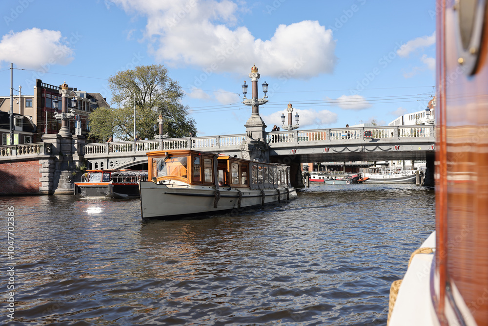 River Amstel in Amsterdam with the Blaauwbrug and saloon boats