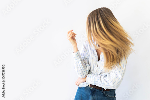 Portrait of a young relaxed Caucasian woman with pleasant smile isolated on white wall background 