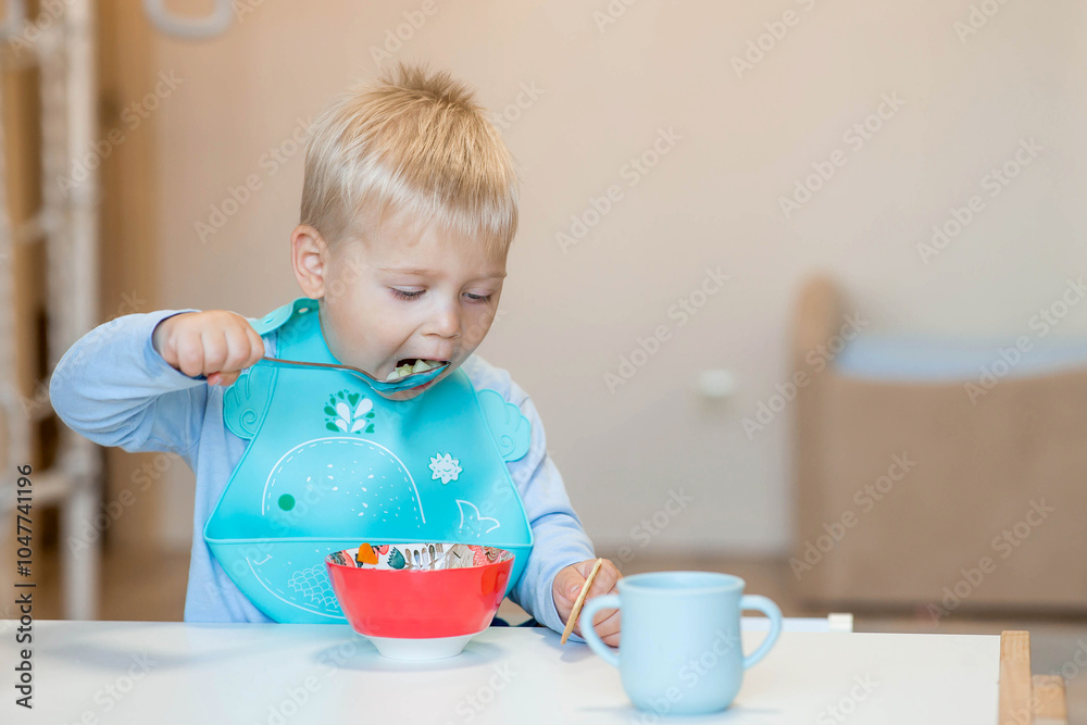 Baby food. Eating. Feeding the baby. A cute kid eats on his own with a spoon. Healthy eating. Family and children. Baby food. Eating. Feeding the baby. A cute kid eats on his own with a spoon. Healthy eating. Family and children.