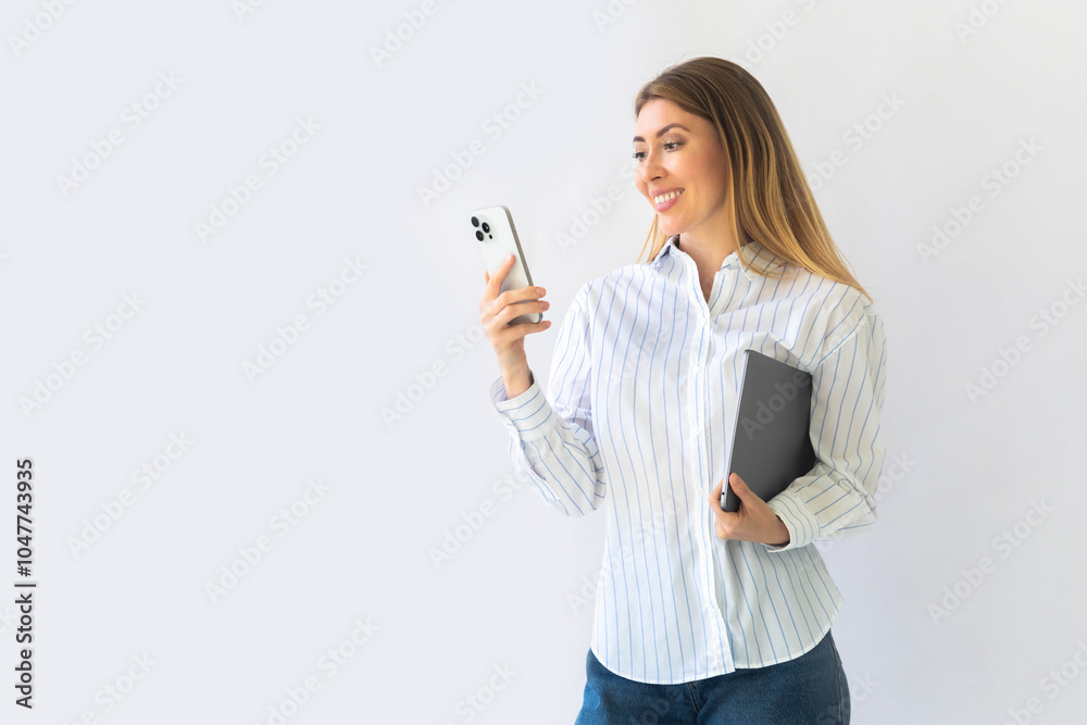 Caucasian businesswoman in formal attire in her office happy and cheerful while using smartphones Caucasian businesswoman in formal attire in her office happy and cheerful while using smartphones