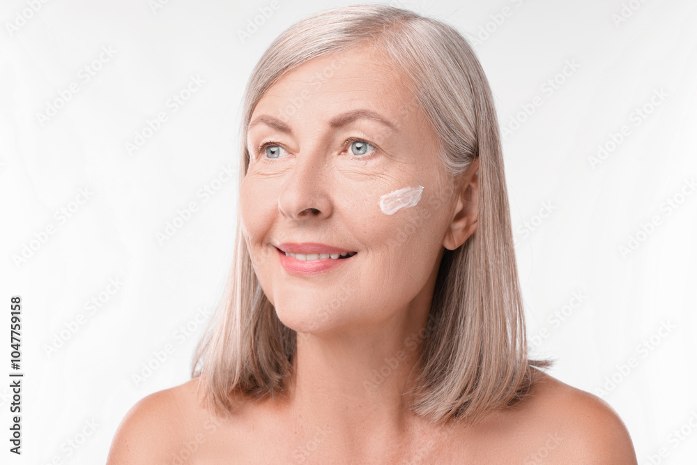 Senior woman with face cream on white background Senior woman with face cream on white background