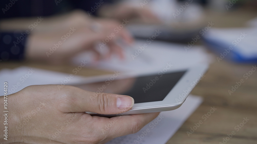 Fototapeta premium Accountants or auditors reviewing financial documents while sitt
