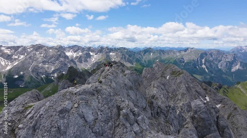 Drone aerial of Colac rocky mountain peak with people, Dolomites (Canazei). Via Ferrata dei Finanzieri. Sassolungo (Sasslong), Sella Pass and Pordoi background photo