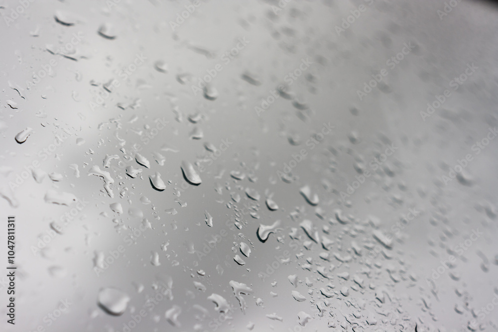 Raindrops on window glass. Autumn cloudy sky Raindrops on window glass. Autumn cloudy sky