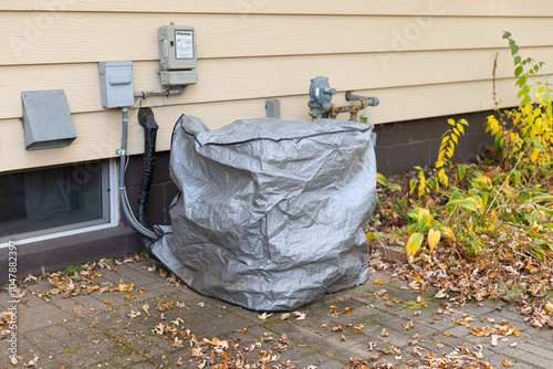 Air conditioner unit with protective cover on. 