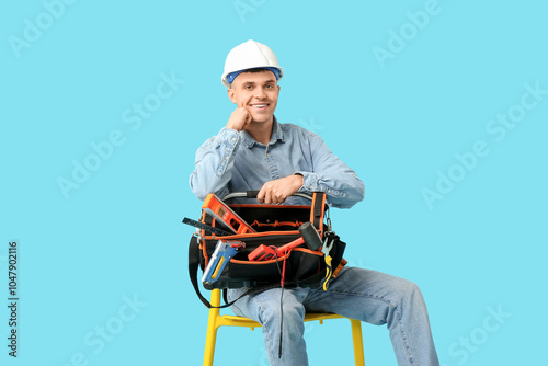 Young male electrician with...