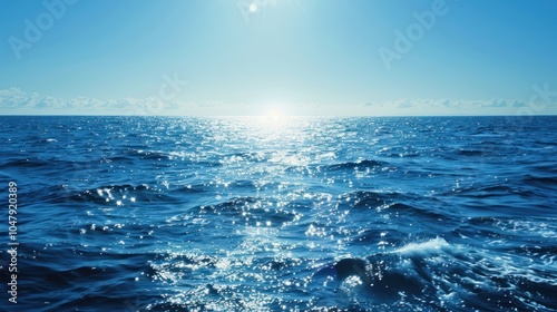 Blue Ocean Waves with Bright Sun Glimmering on the Water Surface