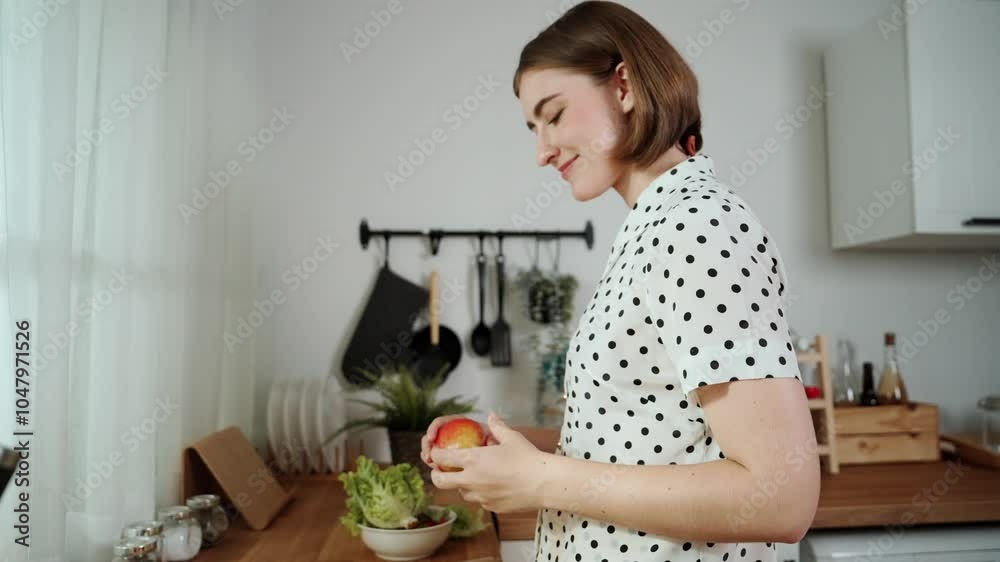 Energetic mother select fruit for making healthy food and looking at camera while hold fresh apple. Happy house keeper enjoy cooking while doing food preparation for making salad at kitchen. Pedagogy. Energetic mother select fruit for making healthy food and looking at camera while hold fresh apple. Happy house keeper enjoy cooking while doing food preparation for making salad at kitchen. Pedagogy.
