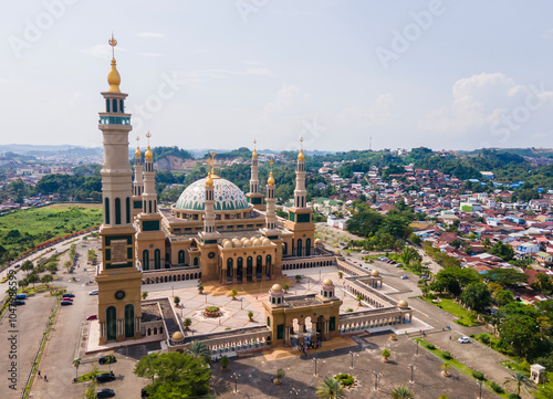 Aerial view of Baitul Muttaqien Mosque, the biggest mosque and islamic center in Samarinda, East Kalimantan, Indonesia. Located on the banks of the Mahakam River. photo