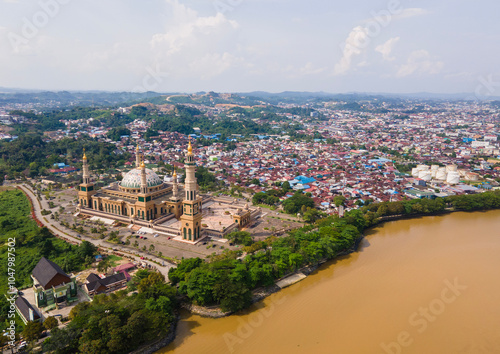 Aerial view of Baitul Muttaqien Mosque, the biggest mosque and islamic center in Samarinda, East Kalimantan, Indonesia. Located on the banks of the Mahakam River. photo