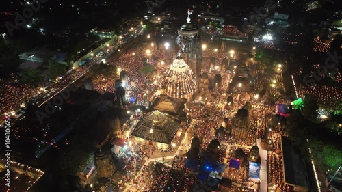 Aerial view of Lingaraj Temple in Bhubaneswar, Odisha, illuminated and crowded with devotees celebrating Shivratri in a lively, festive atmosphere at night. photo