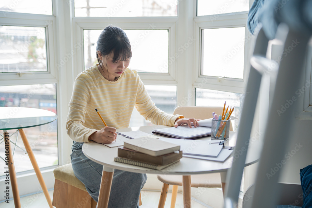 Student asian woman reading book in dorm room college student do homework in university dormitory Student asian woman reading book in dorm room college student do homework in university dormitory