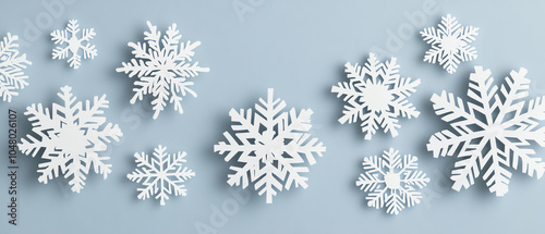 Collection of delicate white snowflakes on a soft blue background, ideal for winter-themed designs and seasonal decorations.