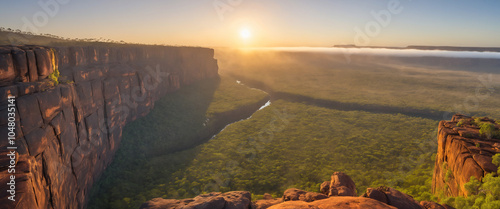 A serene and misty dawn breaks over the rugged Mitchell Plateau in Western Australia, with the mist-shrouded rocky outcroppings. photo