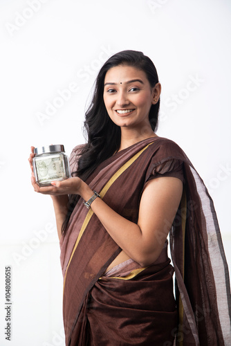 Indian Wife In Saree Holding Money Glass Jar In Hand
