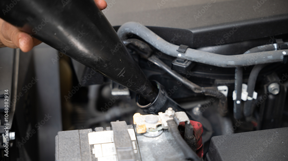 Fototapeta premium Mechanic in vehicle repair work, changing fluids and brake system