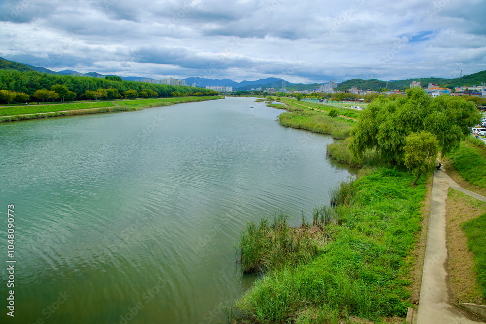 Upriver View of Taehwagang River with Lush Riverbanks Upriver View of Taehwagang River with Lush Riverbanks