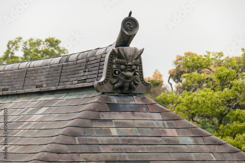 Fotografie Details of the beautiful typical Japanese style roof of a house in the park surrounding the golden Kinkakuji temple in Kyoto, Japan