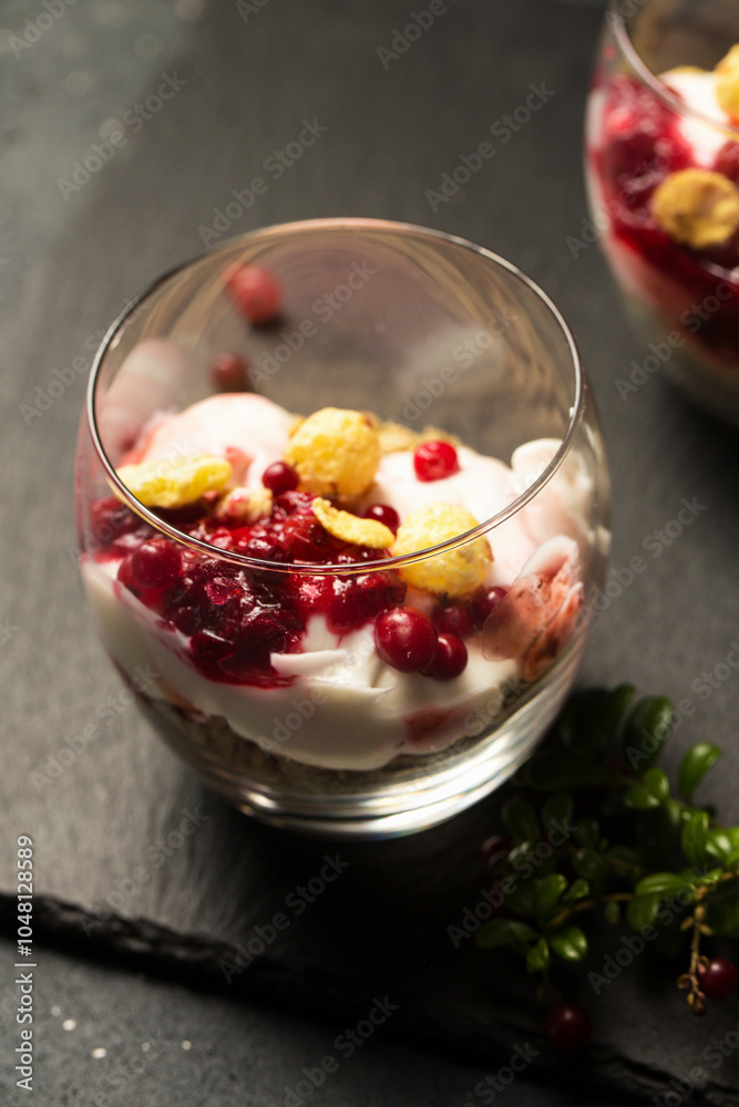 Two glasses of dessert with berries and nuts Two glasses of dessert with berries and nuts