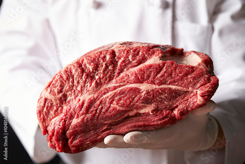 Fresh beef chunks in the chef's hand	 photo