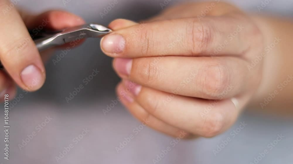 Close up of woman doing her nails at home, removing cuticles from fingers, natural manicure Close up of woman doing her nails at home, removing cuticles from fingers, natural manicure