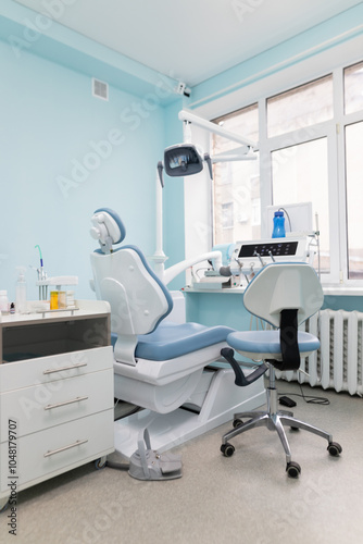 Modern dental clinic interior featuring a treatment chair and equipment during daylight for patient care and comfort