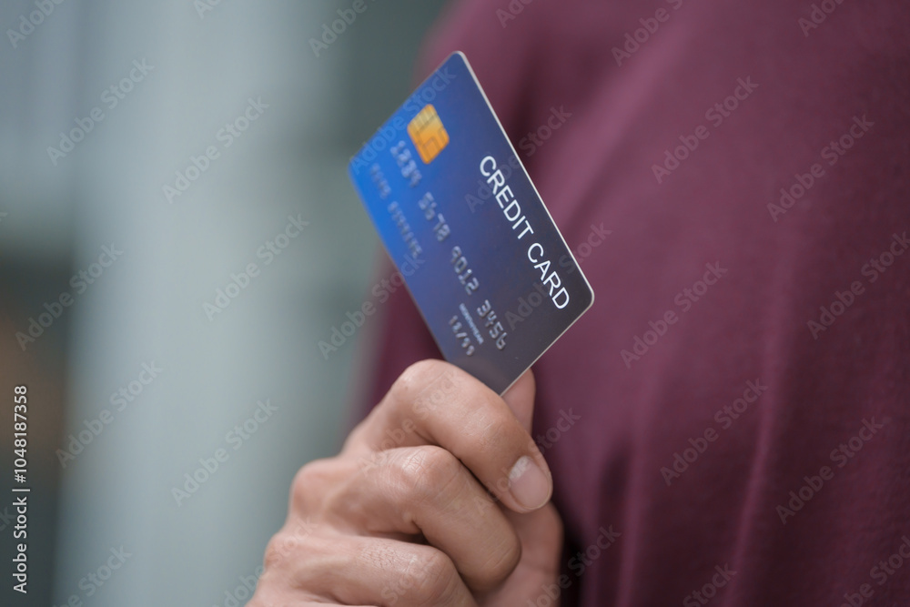 Close-up of a man's hand holding a bank credit card, highlighting online services for lending and access to credit,demonstrating financial convenience and flexibility for secure digital transactions Close-up of a man's hand holding a bank credit card, highlighting online services for lending and access to credit,demonstrating financial convenience and flexibility for secure digital transactions