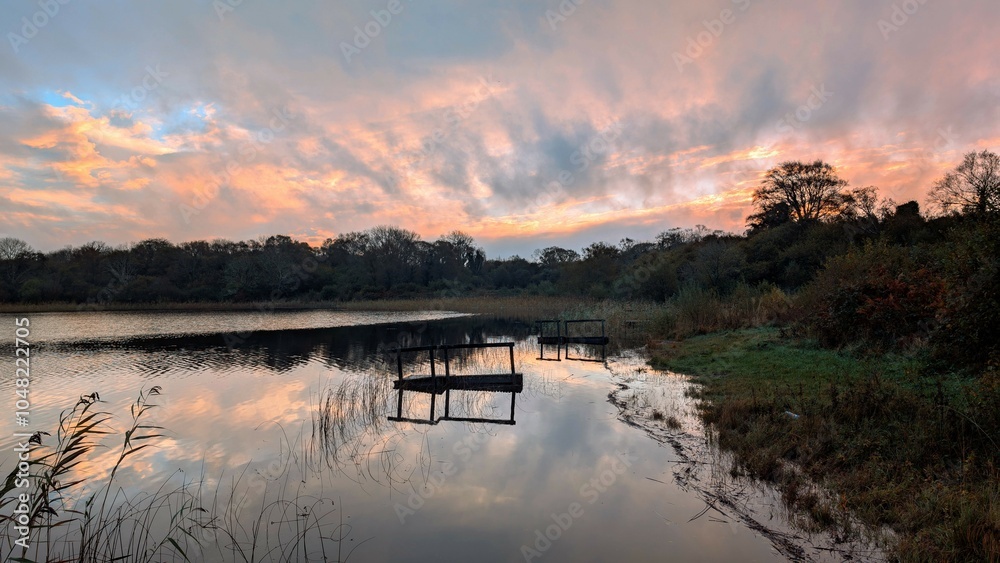 Sunrise lakeside landscape scenery, flooded fishing dock, jetty at Ballyqiurke lough, Moycullen, Galway, Ireland, nature background