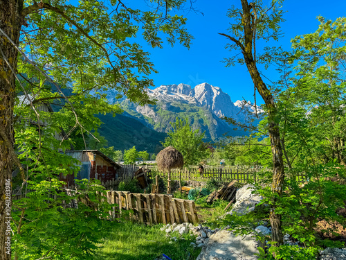 Picturesque mountain landscape with traditional rural scene in Albanian Alps (Accursed Mountains), Albania. Small wooden shed and a hay bale on remote farm in Valbone Valley National Park. Tranquility photo